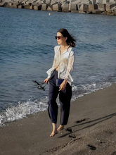 A woman wears map-printed shirt
